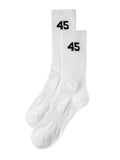 A pair of white Mfourfive ribbed crew socks laid flat, displaying the black 45 logo on the upper ankle.