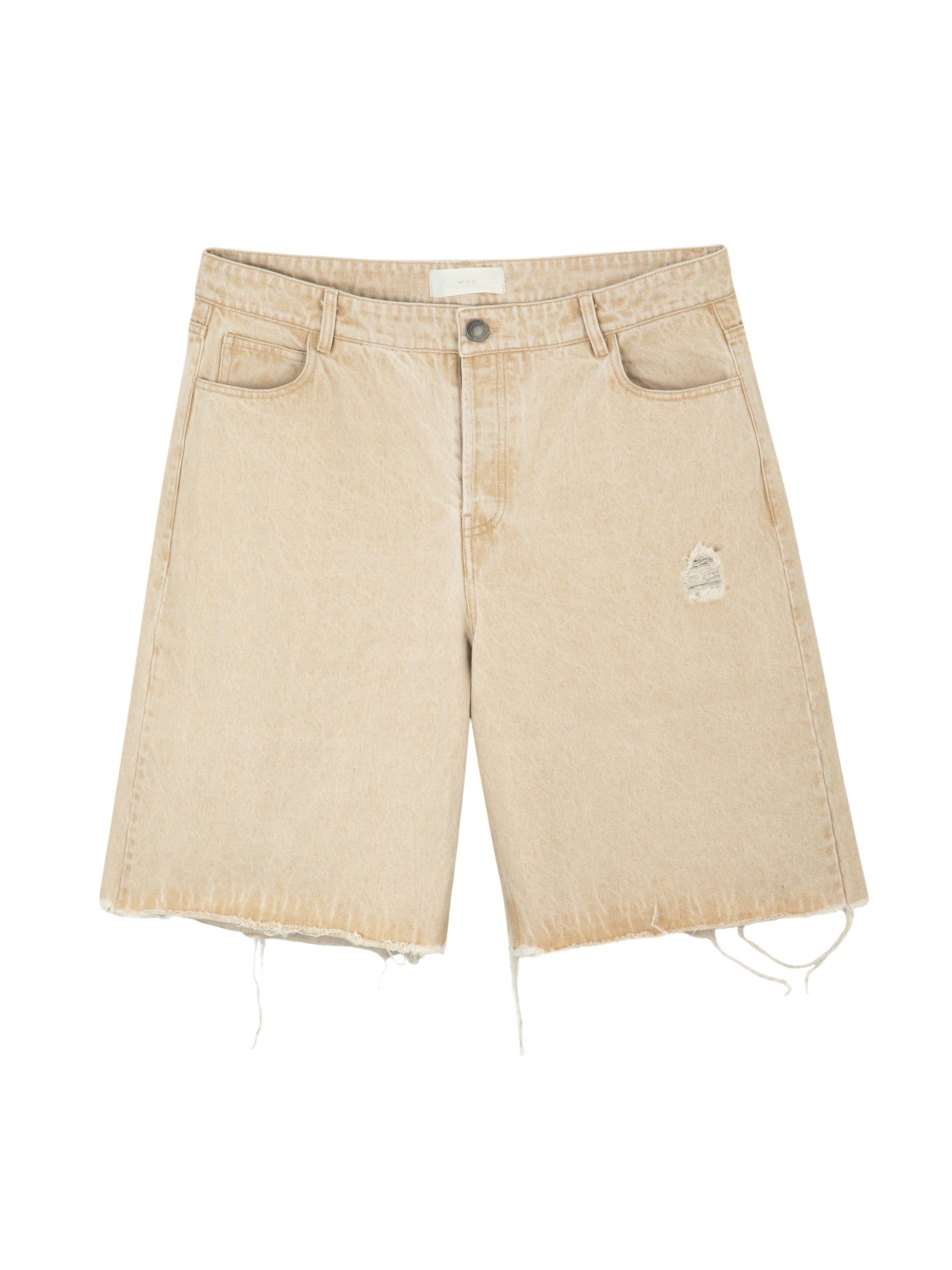 Front view of sand beige Mfourfive denim jorts featuring a raw frayed hem and a small distressed patch on the left thigh.