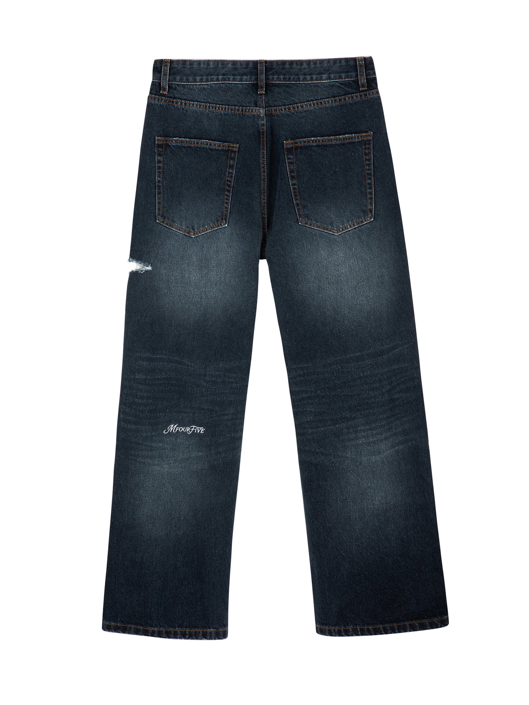Back view of dark indigo wash Mfourfive relaxed jeans displaying vintage fading and a white embroidered logo on the lower left leg.
